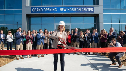 someone cutting ribbon to new building